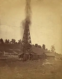 Spewing: Gusher spewing oil from top of a derrick ?