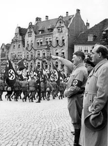 Admired: Gyula Goemboes with Adolf Hitler inspect an SA procession, 1