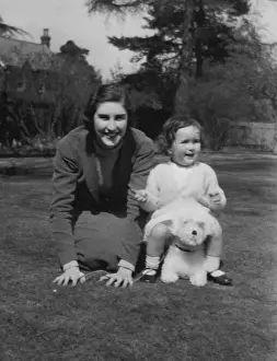 Pretending: Two half sisters playing with a toy dog