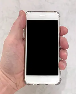 Clear: A hand holding a modern touch-screen mobile phone