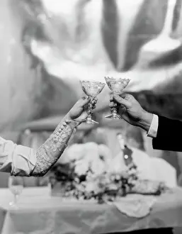 Clinking: Hands & Arms Of A Bride And Groom