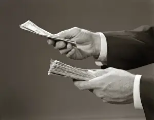 Currencies: Hands close-up holding stack of money bank notes