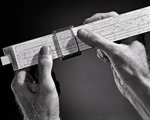 Analog: Hands Holding Slide Rule a Mechanical Analog Computer