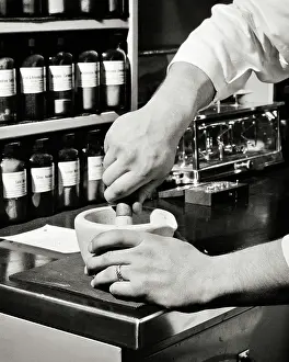 Pestle: Hands of Male Chemist Using a Mortar and Pestle