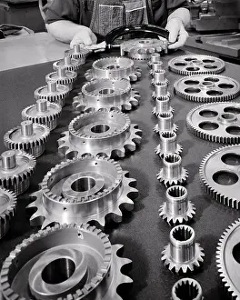 Spindles: Hands Performing Quality Check on 3 Assembled Gear Pieces