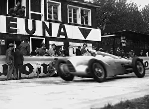 Establishes: Hans Stuck in his racing car, 1934
