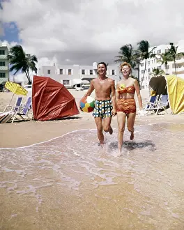 Sch002: Happy Couple Looking at Camera Running on Tropical Beach