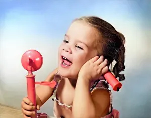 Networking: Happy Little Girl Talking into