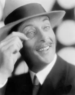Monocles: Happy looking man with a monocle in his hand