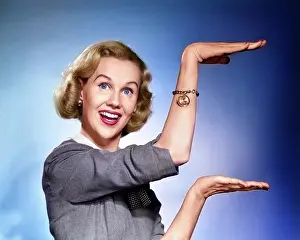 Describing: Happy Smiling Blond Woman Looking at Camera Gesturing
