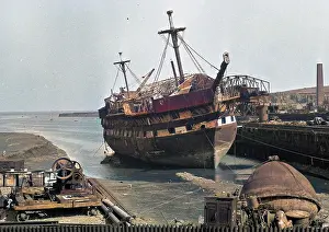 Neglected: Harbour scene with ship and equipment, Scotland