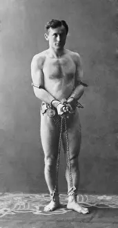 Illusionists: Harry Houdini, escapologist, in chains