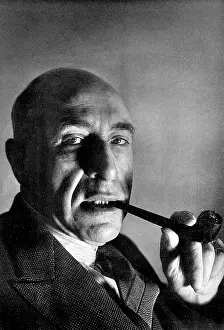Smokes: Harry Price smoking a pipe