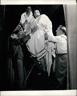 Outsize: Hattie Jacques on step ladder with prop men