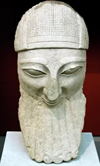 Devout: Head from a colossal statue of a bearded worshipper with hel