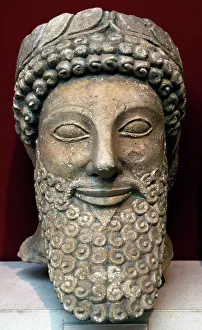 Devout: Head from a statue of a bearded man with laurel wreath. 5th