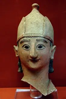 Devout: Head from a statue of a warrior with conical helmet. 625-600