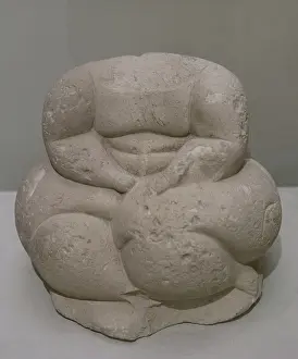Hagar: Headless sculpture of a seated human figure. From