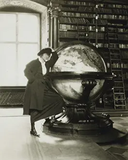 Kirtland: Helen Johns Kirtland leaning on a globe