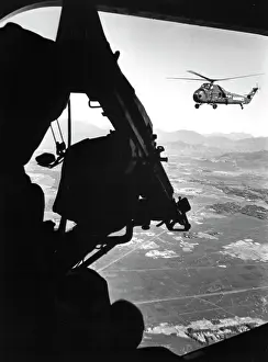 Overlooking: Helicopter and soldier approaching target in Vietnam