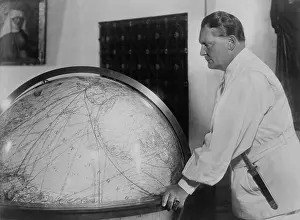 Air Force: Hermann Goering, leaning toward a large globe in