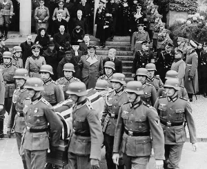 Accompanies: Hermann Goring at the funeral of Fritz Rigele, 1937