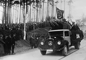 Usz62: Hermann Goring in group at left receives ?