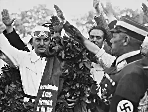 Avus: Hermann Lang with a victory wreath, 1937