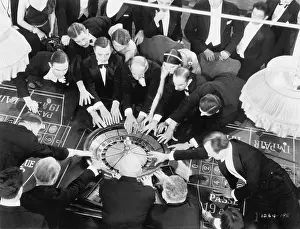 Aerials: High angle of a group of people playing roulette