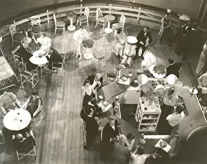Art Nouveau: High angle view of people at cocktail lounge aboard ship