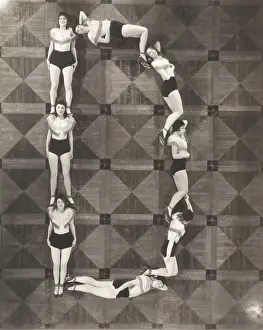 Coordinate: High angle view of women forming the letter D