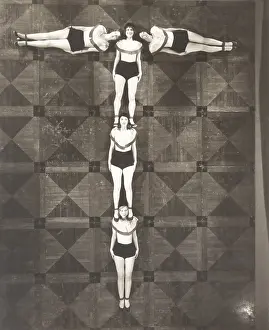Coordinate: High angle view of women forming the letter T