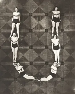 Coordinate: High angle view of women forming the letter U