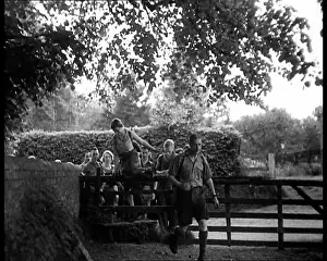 Hikers: Hikers Climbing over a Gate