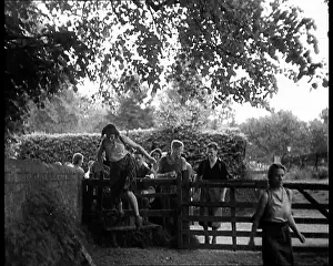Hikers: Hikers Climbing over a Gate