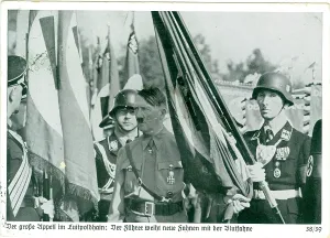 Essence: A serious Hitler presents a new unit its regimental flag