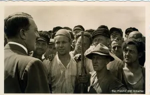 Propagandist: Hitler talking to a group of workers