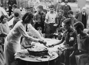 Share: Hitler's birthday cake is being shared, 1934