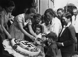 Share: Hitler's birthday cake is being shared, 1934