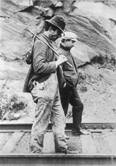 Hobos: Two hobos walking along railroad tracks, ?