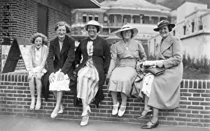 Hildi Reinhart: Holiday group sitting on a wall in Margate, Kent