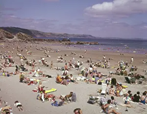 Lilo: Holidaymakers on the beach at Looe, Cornwall