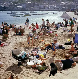 Holidaymakers on the harbour beach, St Ives, Cornwall
