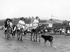 Holidaymaker: Holidaymakers riding donkeys on a beach