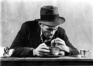 Breadline: Homeless Man Eating in a Soup Kitchen