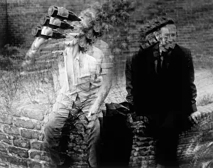 Convey: Two homeless men sitting on a wall