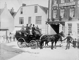 A horse drawn bus and passengers waiting in the
