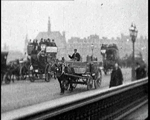 Horse Drawn Carriages and Buses Driving Along
