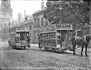 Widened: Two horse-drawn trams passing in the street with
