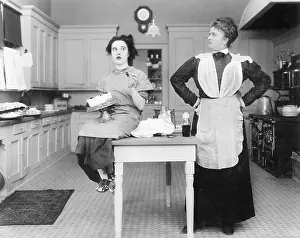 Glare: Housekeeper in the kitchen glaring at a young woman